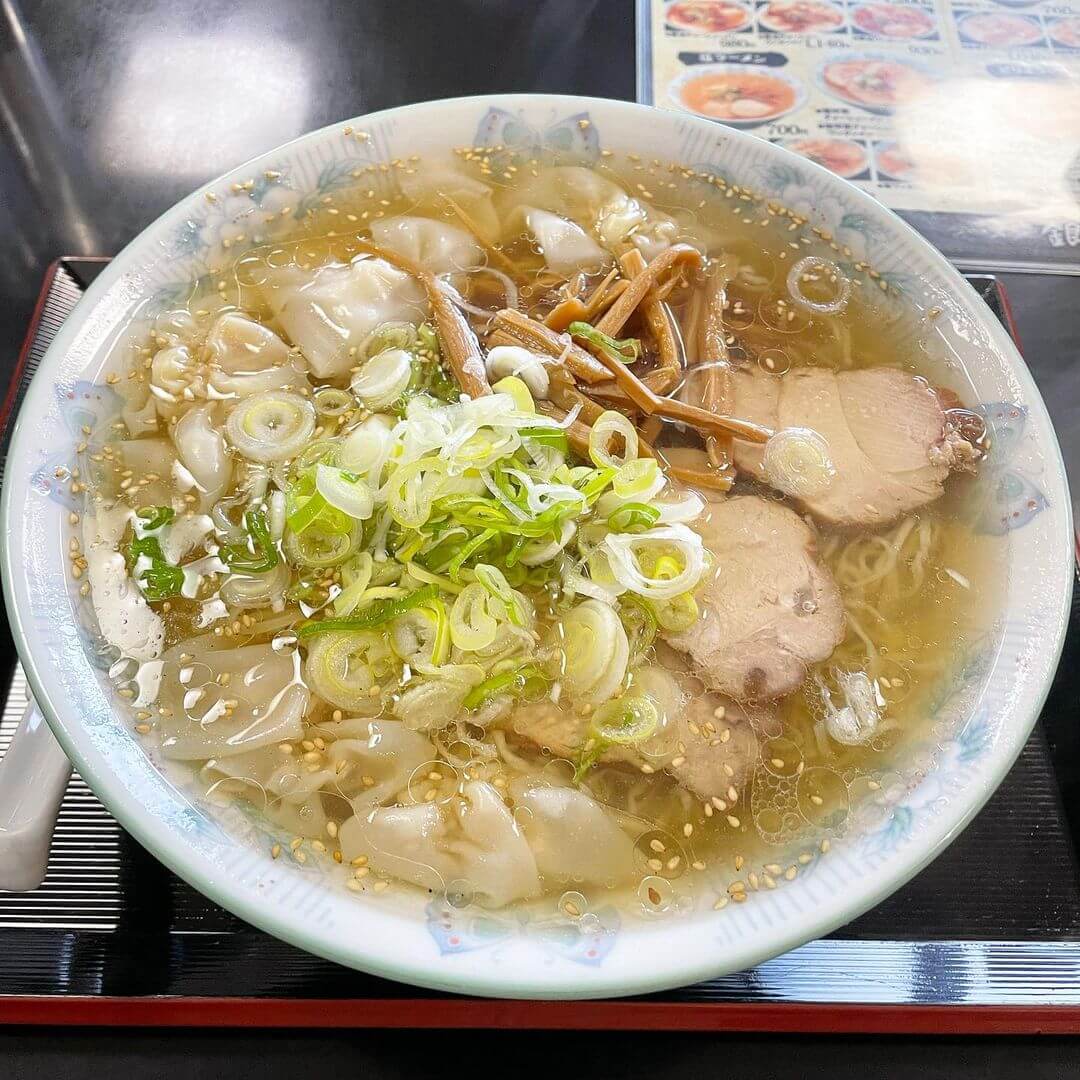 A bowl of Kushiro ramen, a local Hokkaido ramen type, with wontons as an extra topping.