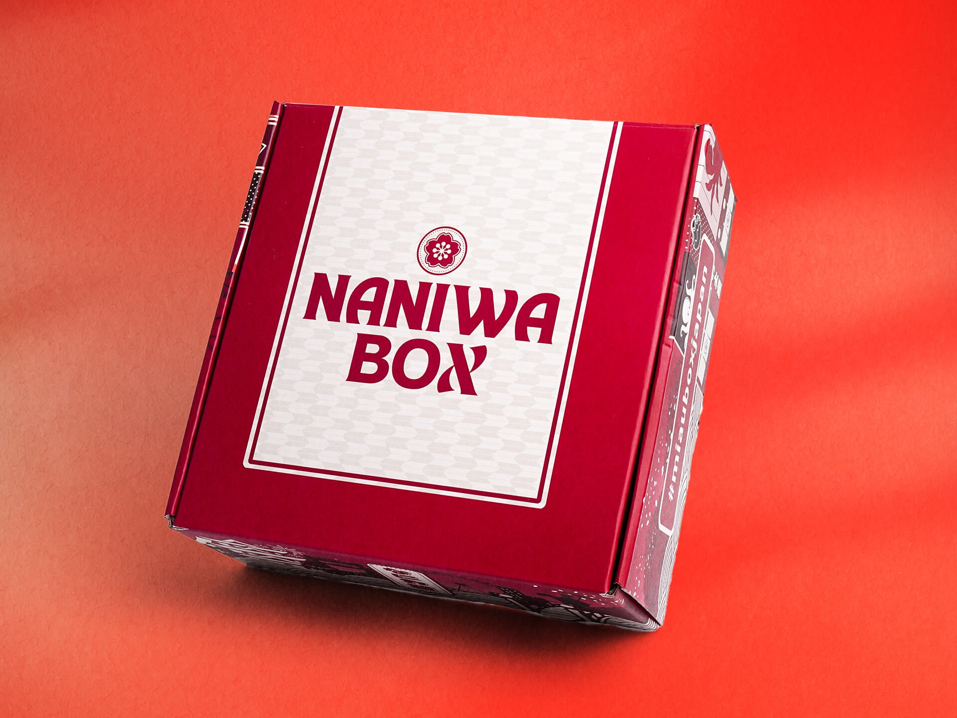 A red and white Japanese snack box Naniwa Box in front of a red background