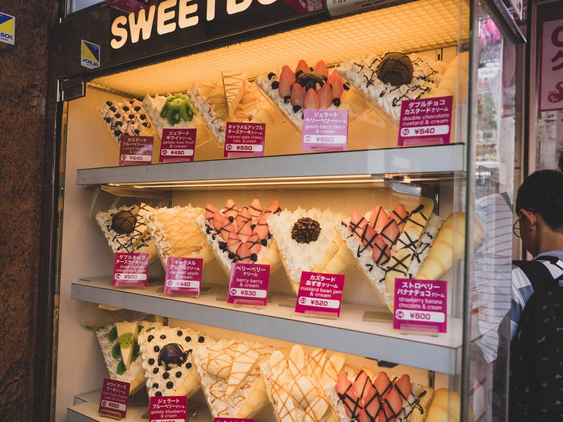 The display window of a Japanese crepe shop with many tasty items