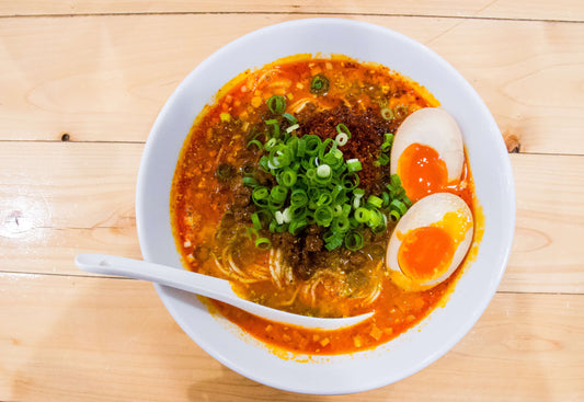 A bowl of Nagoya's Taiwan Ramen with a red soup