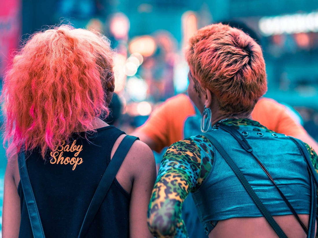 Two friends with pink-orange hair stand in Shibuya with unique outfits